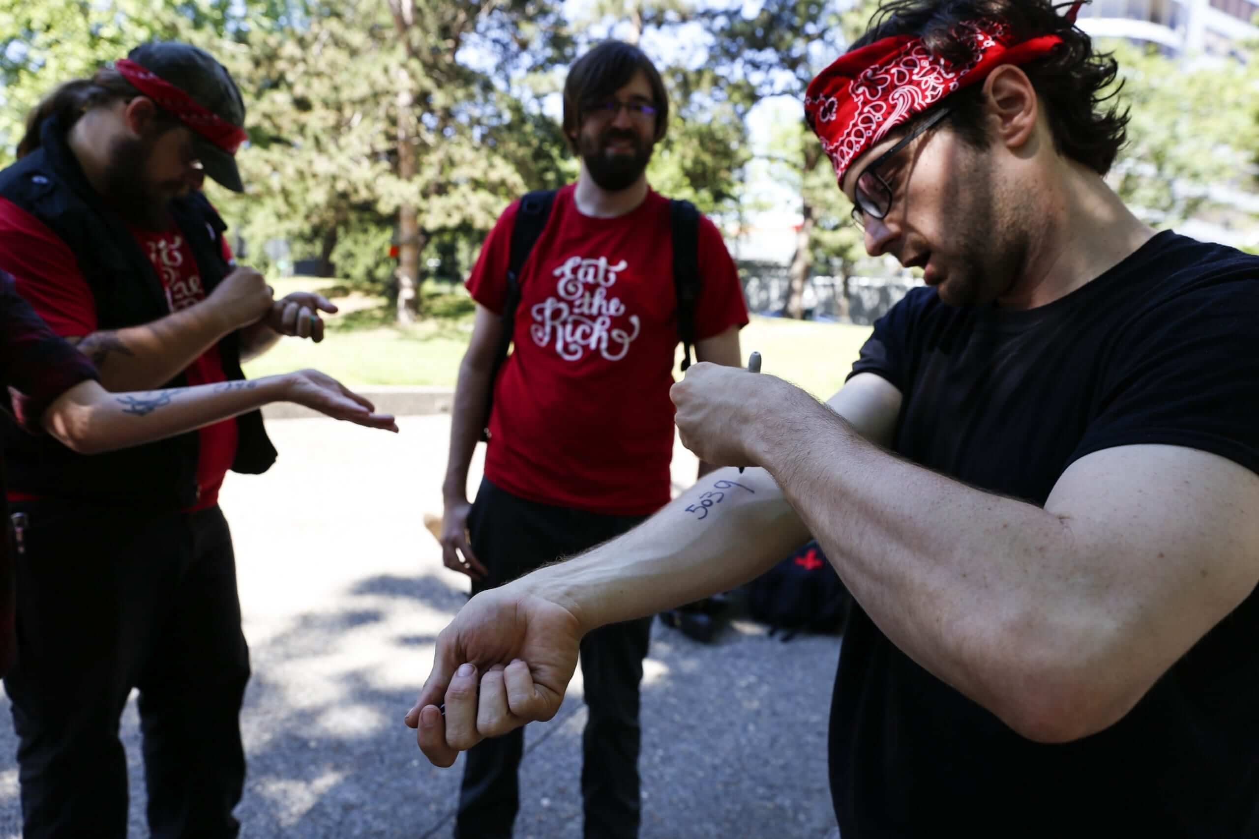 PORTLAND, OR - JUNE 29: Democratic Socialists of America, or DSA, members write the phone number of the National Lawyers Guild in case they get injured during a Portland demonstration between the right and left on June 29, 2019 in Portland, Oregon. Several groups from the left and right clashed after competing demonstrations at Pioneer Square, Chapman Square, and Waterfront Park spilled into the streets. According to police, medics treated eight people and three people were arrested during the demonstrations.