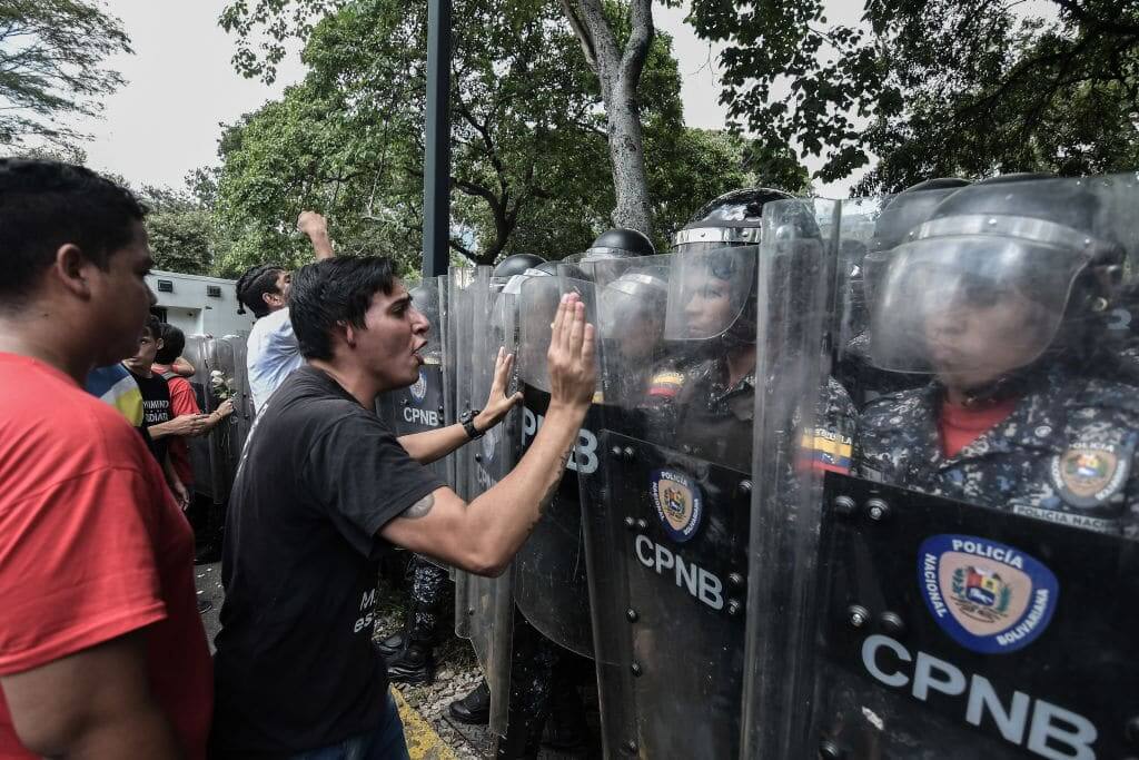 CARACAS, MIRANDA, VENEZUELA - 2019/11/14: Protester utters insults at the riot police during the demonstrations. Tension rose in Venezuela after university students protested in the streets in support of the call made by the Venezuelan opposition to remain in the streets without return, indefinitely.